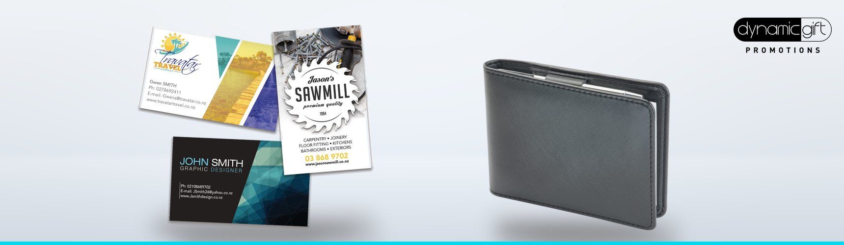 Full colour printed business cards fanned out beside a black leather business card holder on a light background